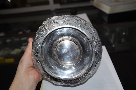 An early 20th century Chinese white metal pedestal bowl, embossed with dragons, 13.5 oz.